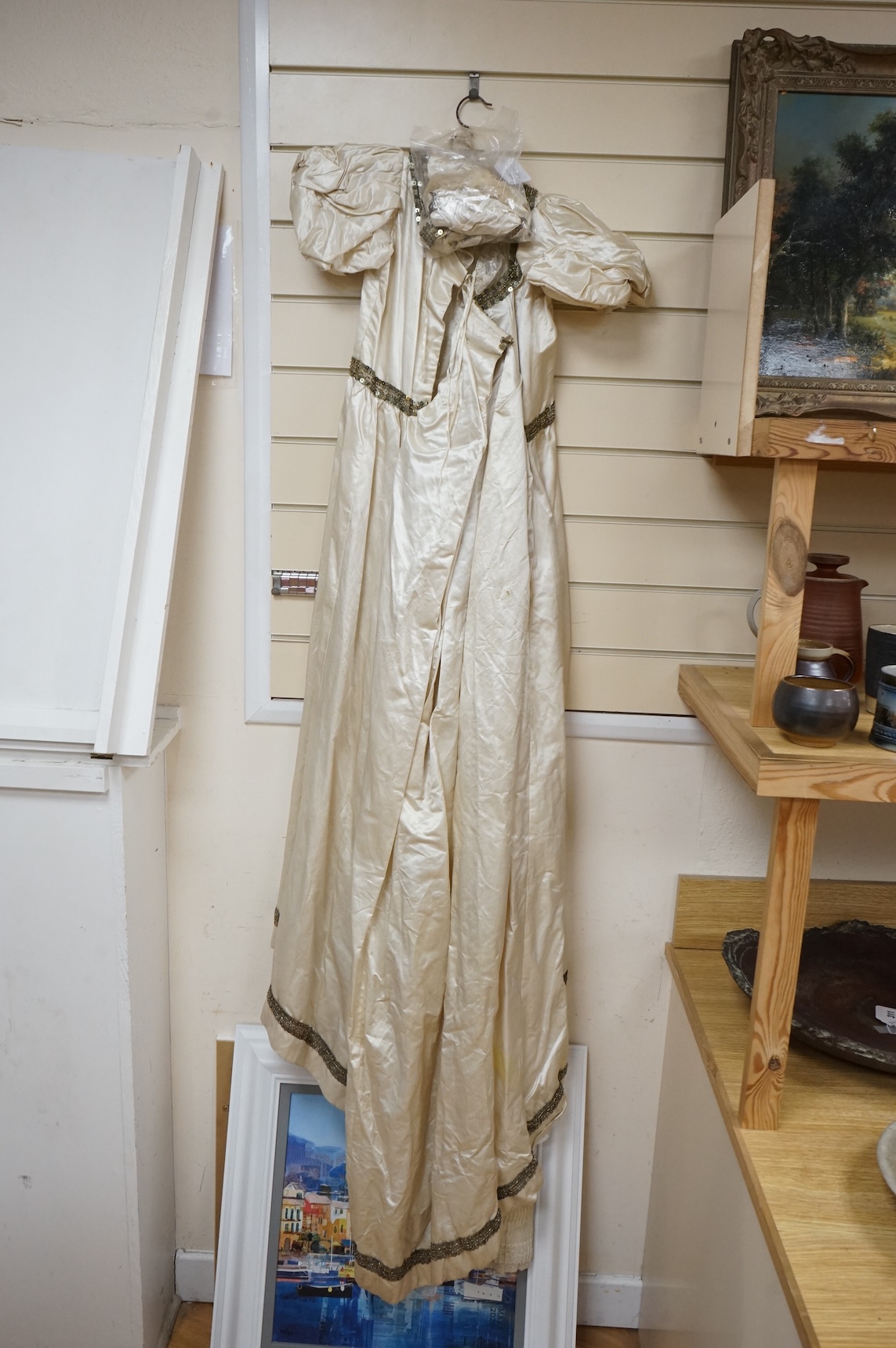 A cream silk satin theatrical costume, mounted with sequined braiding and pair of novelty shoes. Bust measurement 30inches.